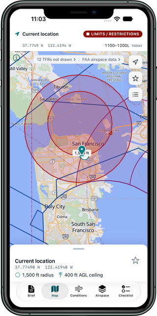 Map of San Francisco with the launch point pinned inside a 1,500 foot operating radius, controlled airspace boundaries outlined in blue and magenta, and two Temporary Flight Restrictions shaded in red