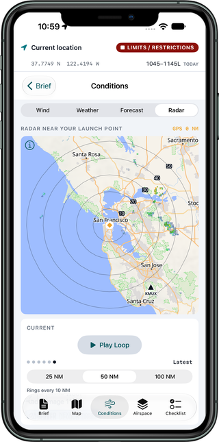 Radar screen showing NEXRAD reflectivity around a launch point in San Francisco at 50 nautical miles, with range rings labeled every 10 nautical miles, the KMUX radar site marked by a triangle, a Play Loop control and a selector for 25, 50 and 100 nautical miles